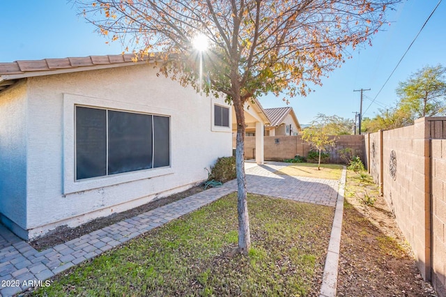 view of side of property with a patio area