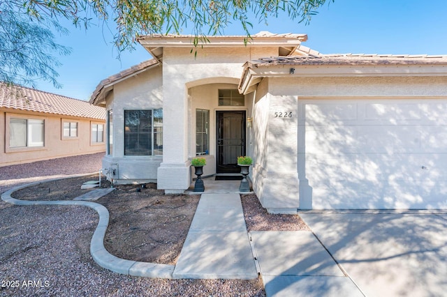 view of exterior entry with a garage