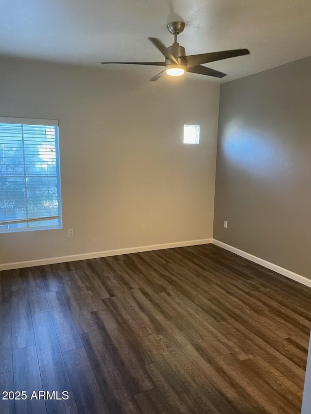 empty room with dark hardwood / wood-style floors and ceiling fan