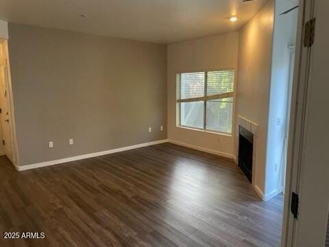 unfurnished living room featuring dark hardwood / wood-style flooring