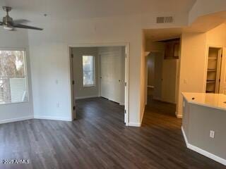 interior space with ceiling fan and dark hardwood / wood-style flooring