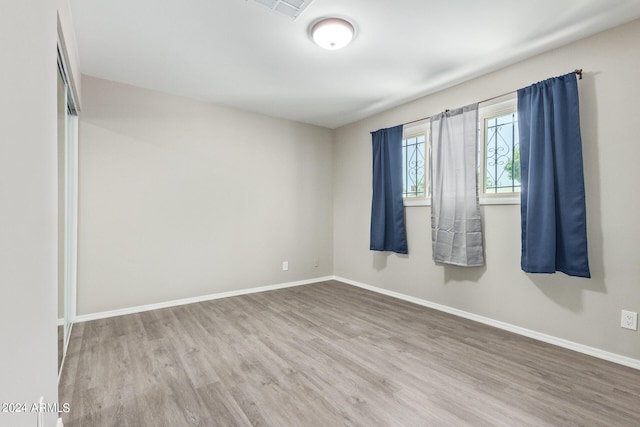 spare room with wood-type flooring