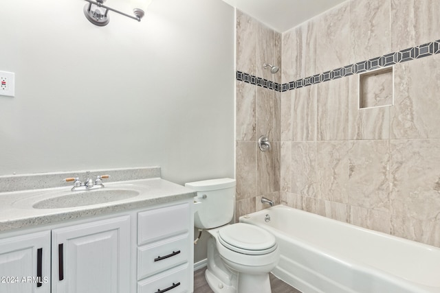 full bathroom with vanity, toilet, and tiled shower / bath