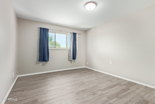 unfurnished room with hardwood / wood-style floors