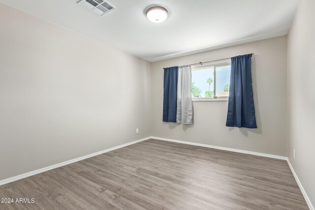 empty room featuring wood-type flooring