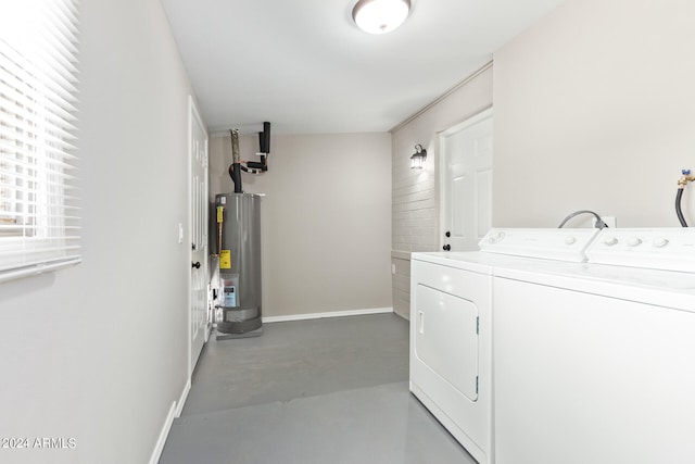 laundry area with water heater and separate washer and dryer