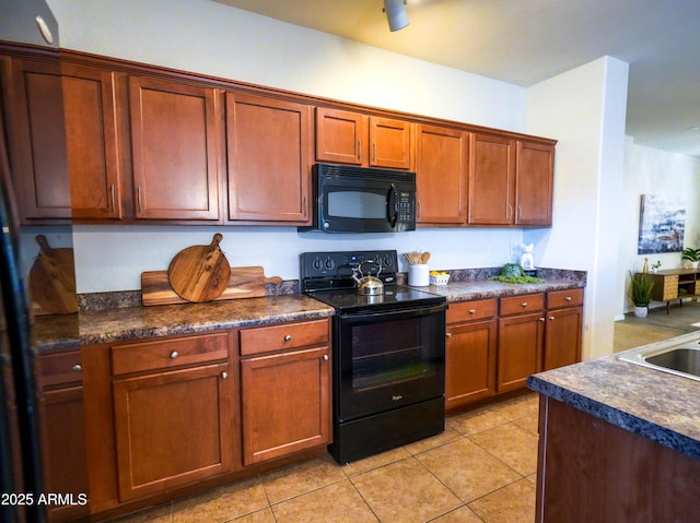 35721 N Zachary Rd, Queen Creek, AZ 85144 - kitchen with dark countertops, light tile patterned floors, and black appliances