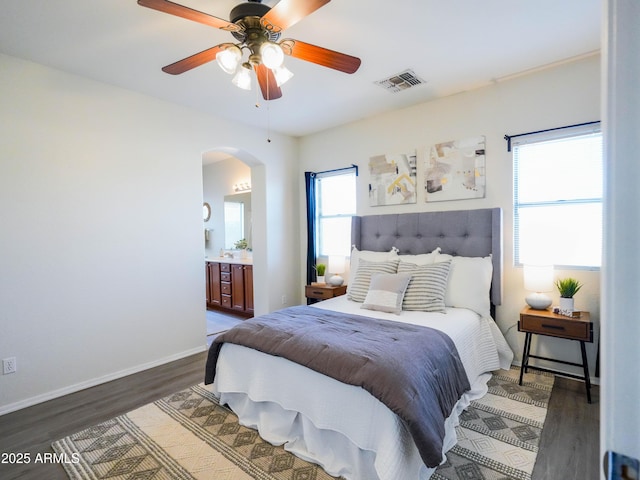 35721 N Zachary Rd, Queen Creek, AZ 85144 - bedroom with ceiling fan, visible vents, arched walkways, wood finished floors, and connected bathroom