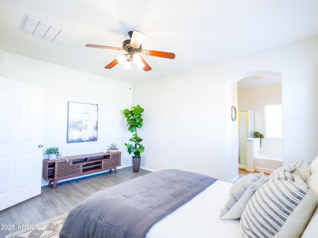 35721 N Zachary Rd, Queen Creek, AZ 85144 - bedroom with arched walkways, a ceiling fan, wood finished floors, and visible vents