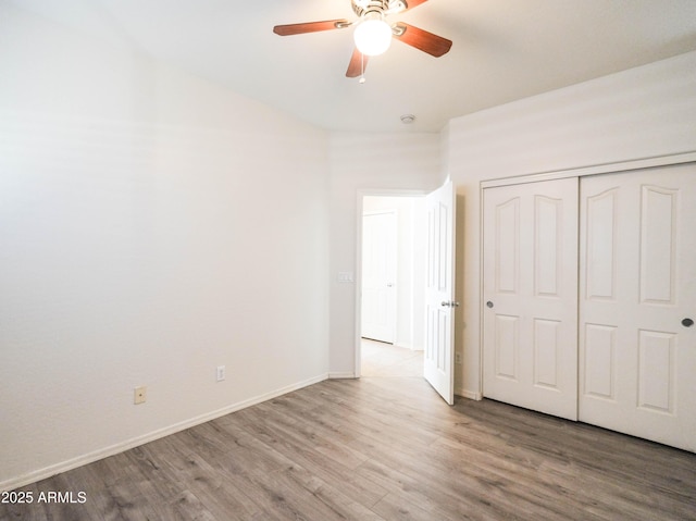 35721 N Zachary Rd, Queen Creek, AZ 85144 - unfurnished bedroom with baseboards, a ceiling fan, a closet, and wood finished floors