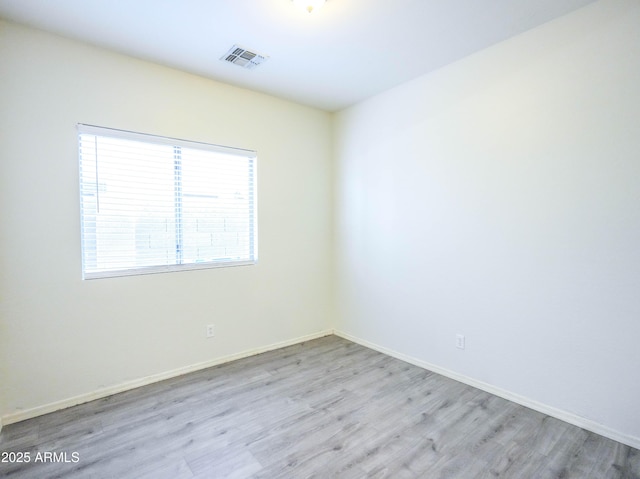 35721 N Zachary Rd, Queen Creek, AZ 85144 - spare room featuring visible vents, baseboards, and wood finished floors
