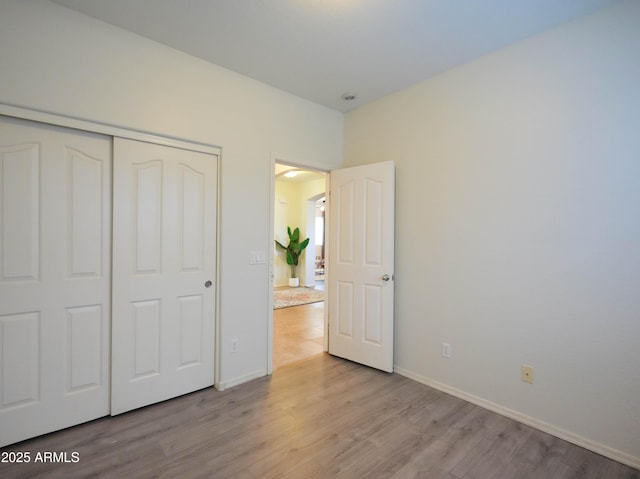 35721 N Zachary Rd, Queen Creek, AZ 85144 - unfurnished bedroom featuring baseboards, wood finished floors, and a closet