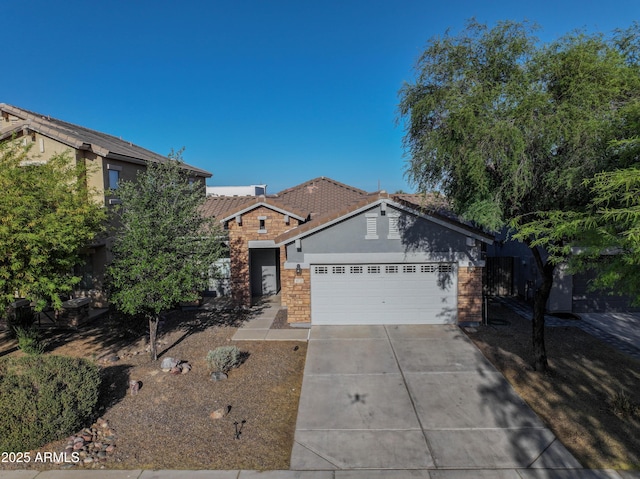 35721 N Zachary Rd, Queen Creek, AZ 85144 - view of front of home featuring an attached garage, stone siding, stucco siding, concrete driveway, and a tiled roof