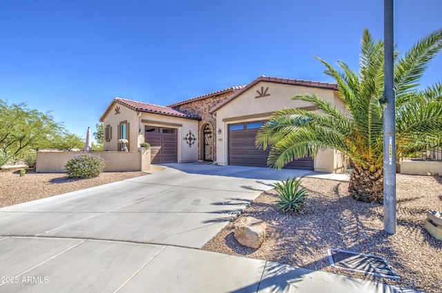 189 N Rainbow Way, Casa Grande, AZ 85194 - mediterranean / spanish-style home featuring an attached garage, driveway, stucco siding, and a tile roof
