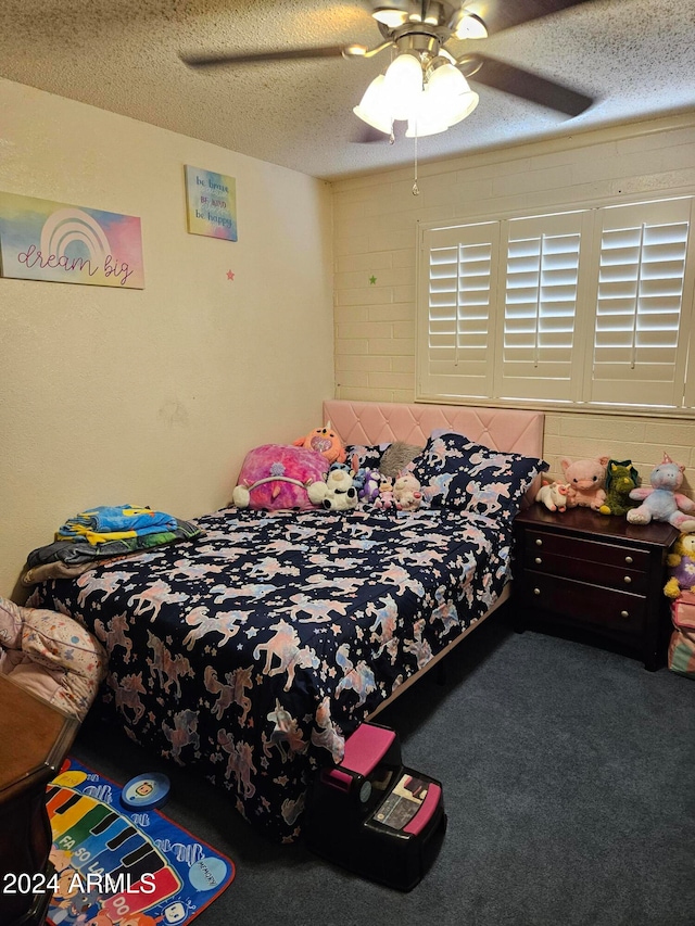 carpeted bedroom featuring a textured ceiling and ceiling fan