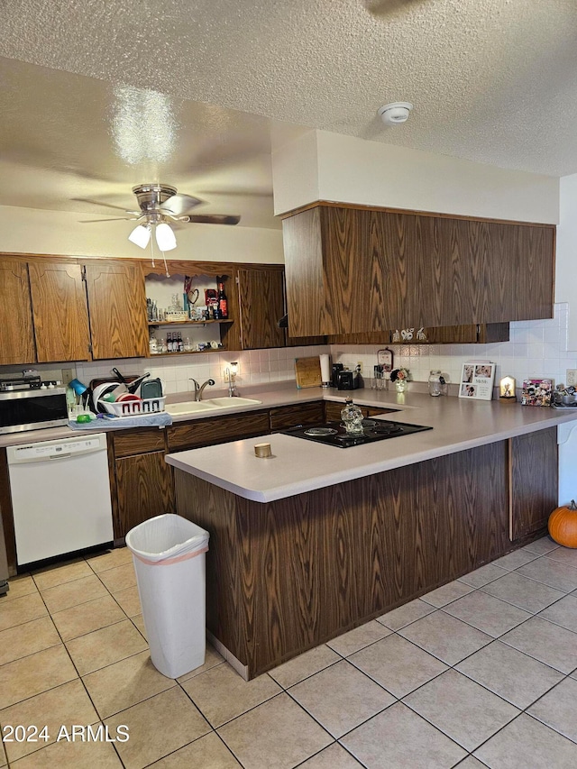 kitchen with light tile patterned flooring, backsplash, white dishwasher, black electric cooktop, and kitchen peninsula