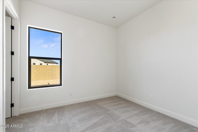 empty room with light carpet and baseboards