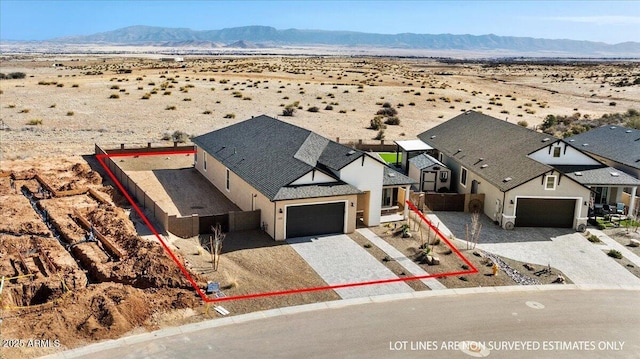 drone / aerial view featuring a desert view and a mountain view