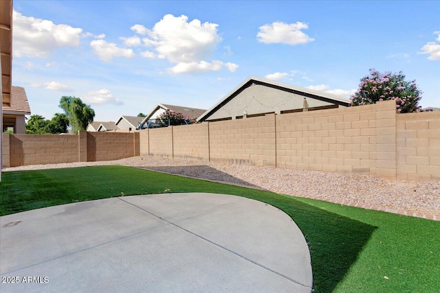 view of yard featuring a patio area and a fenced backyard