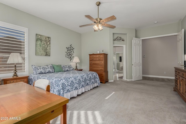 carpeted bedroom with ceiling fan and ensuite bathroom