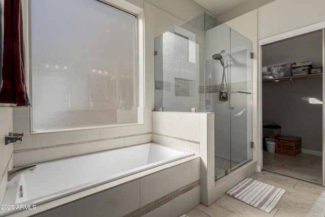 bathroom featuring separate shower and tub