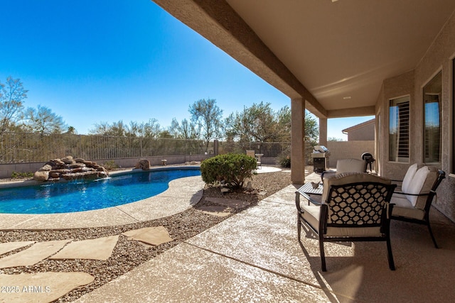 view of pool with pool water feature and a patio area