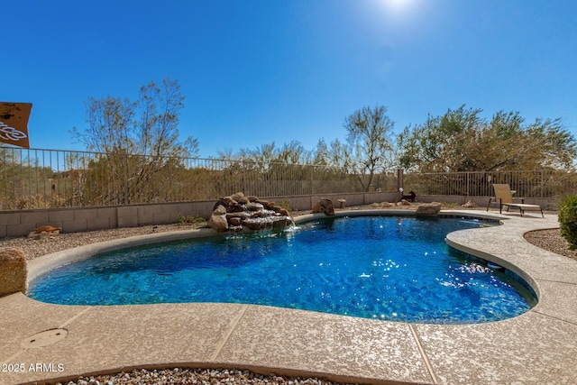 view of swimming pool with pool water feature