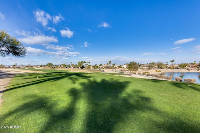 view of community with a yard and a water view