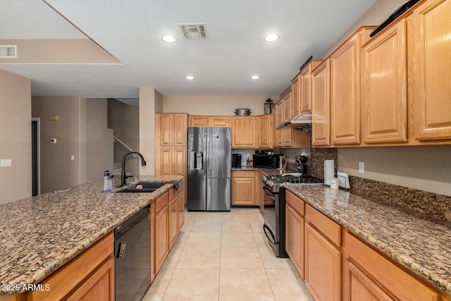 1268 N Pine St, Gilbert, AZ 85233 - kitchen featuring black appliances, dark stone countertops, light tile patterned floors, recessed lighting, and under cabinet range hood