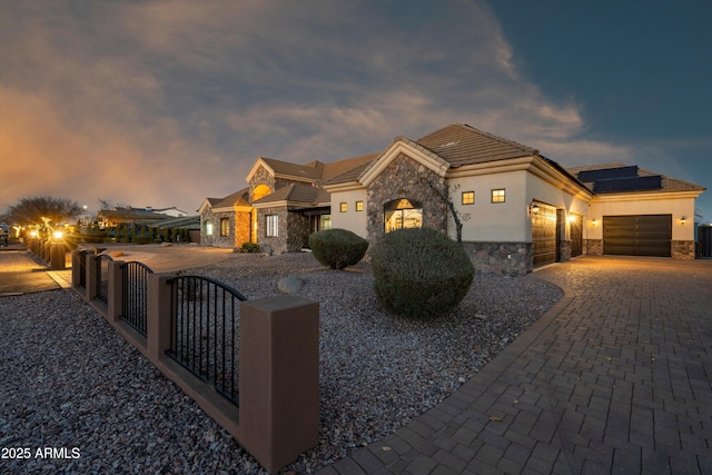 view of front of home featuring a garage and solar panels