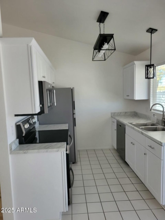 kitchen with light tile patterned flooring, sink, white cabinets, hanging light fixtures, and stainless steel appliances