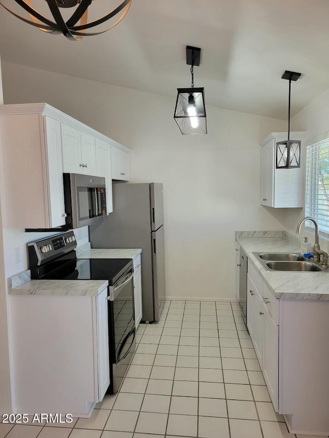 kitchen featuring white cabinetry, stainless steel appliances, sink, and pendant lighting