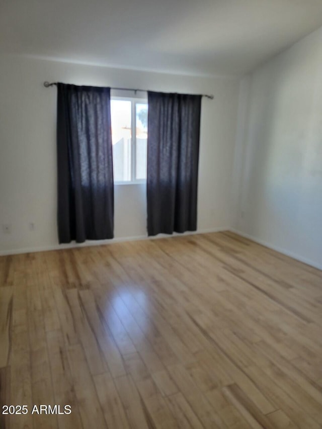 unfurnished room with light hardwood / wood-style floors