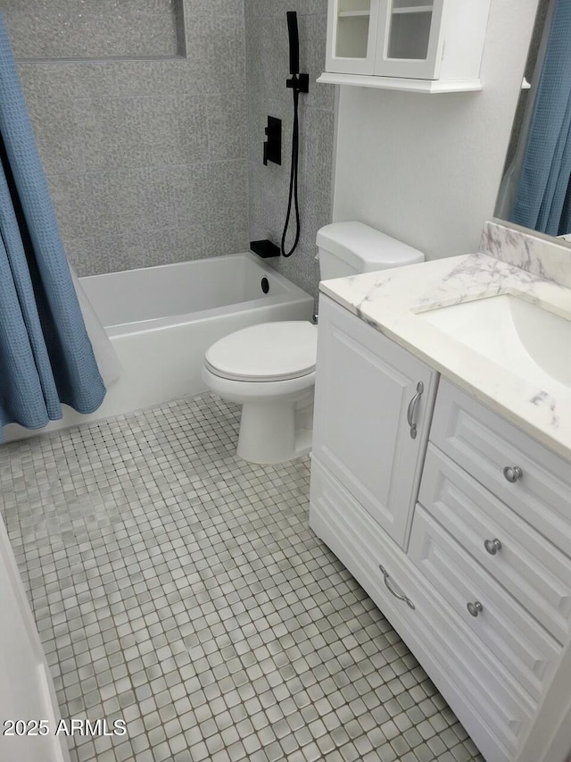 full bathroom featuring vanity, toilet, tile patterned flooring, and shower / bath combo with shower curtain