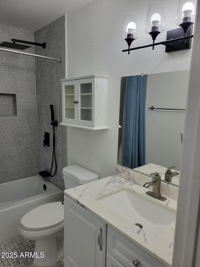 full bathroom featuring vanity, toilet, tile patterned floors, and tiled shower / bath