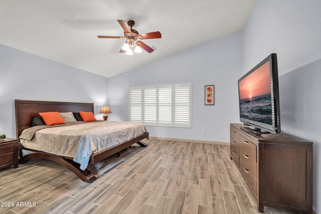 bedroom with ceiling fan, light wood-type flooring, and high vaulted ceiling