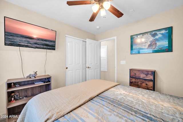 bedroom with ceiling fan and a closet