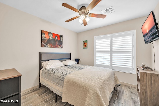 bedroom featuring hardwood / wood-style floors and ceiling fan