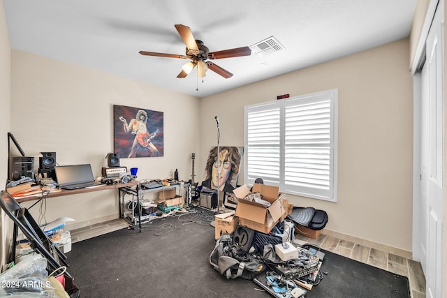 workout room with hardwood / wood-style flooring and ceiling fan