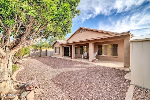 back of property with a patio