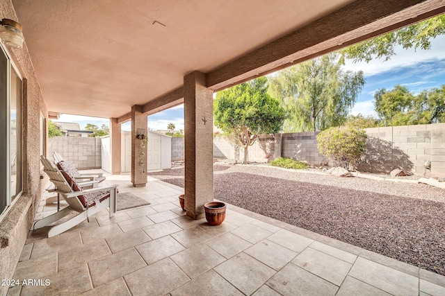 view of patio / terrace with a shed