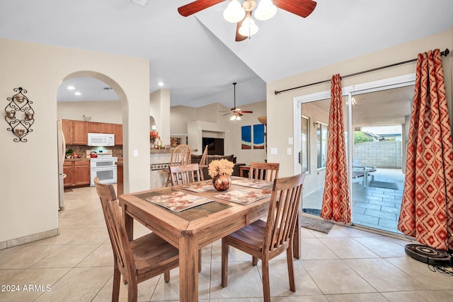 dining space featuring light tile patterned flooring, ceiling fan, and lofted ceiling