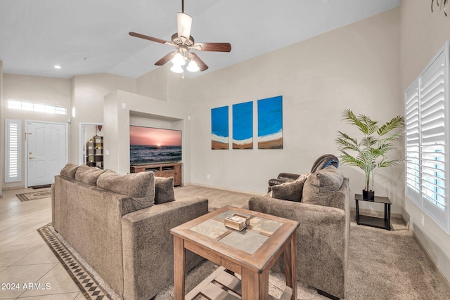 tiled living room featuring a towering ceiling and ceiling fan