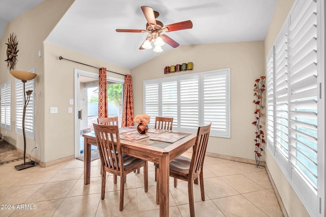 tiled dining space featuring vaulted ceiling and ceiling fan