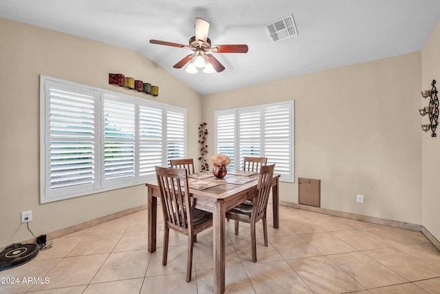 dining room with lofted ceiling, light tile patterned floors, and ceiling fan