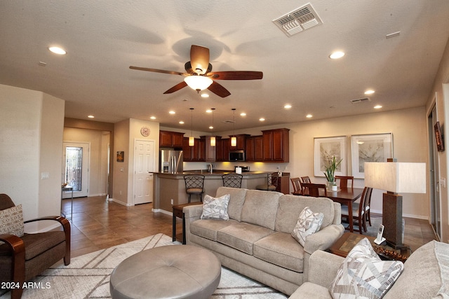 tiled living room featuring ceiling fan