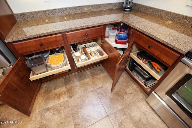 interior details with light stone countertops and stove