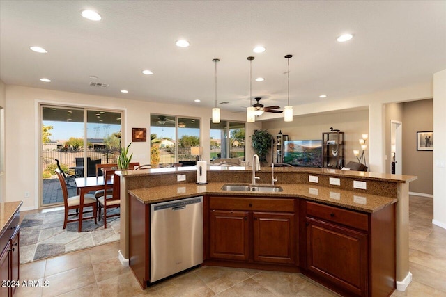 kitchen featuring ceiling fan, sink, stainless steel dishwasher, an island with sink, and pendant lighting