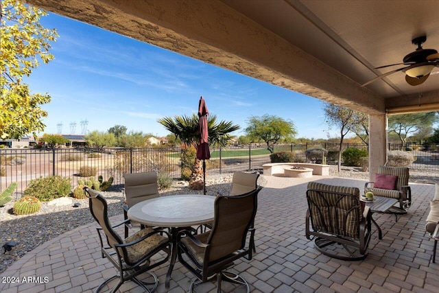 view of patio featuring ceiling fan and a fire pit