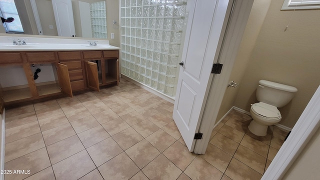 bathroom with tile patterned flooring, vanity, and toilet